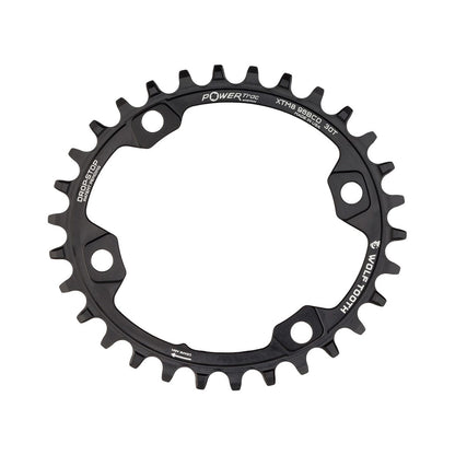 Ovales Einfach-Kettenblatt WOLF TOOTH ELLIPTISCH 96 BCD 11-fach Shimano XT M8000/SLX M7000, 4-Loch, 96 mm, Schwarz — Kettenblatt auf weißem Hintergrund